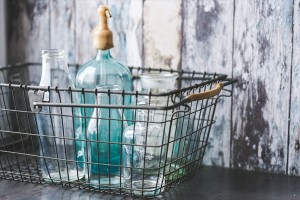 kaboompics.com_Vintage empty bottles in metal basket